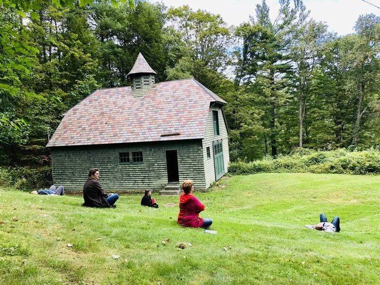 Retreat participants meditating on the lawn