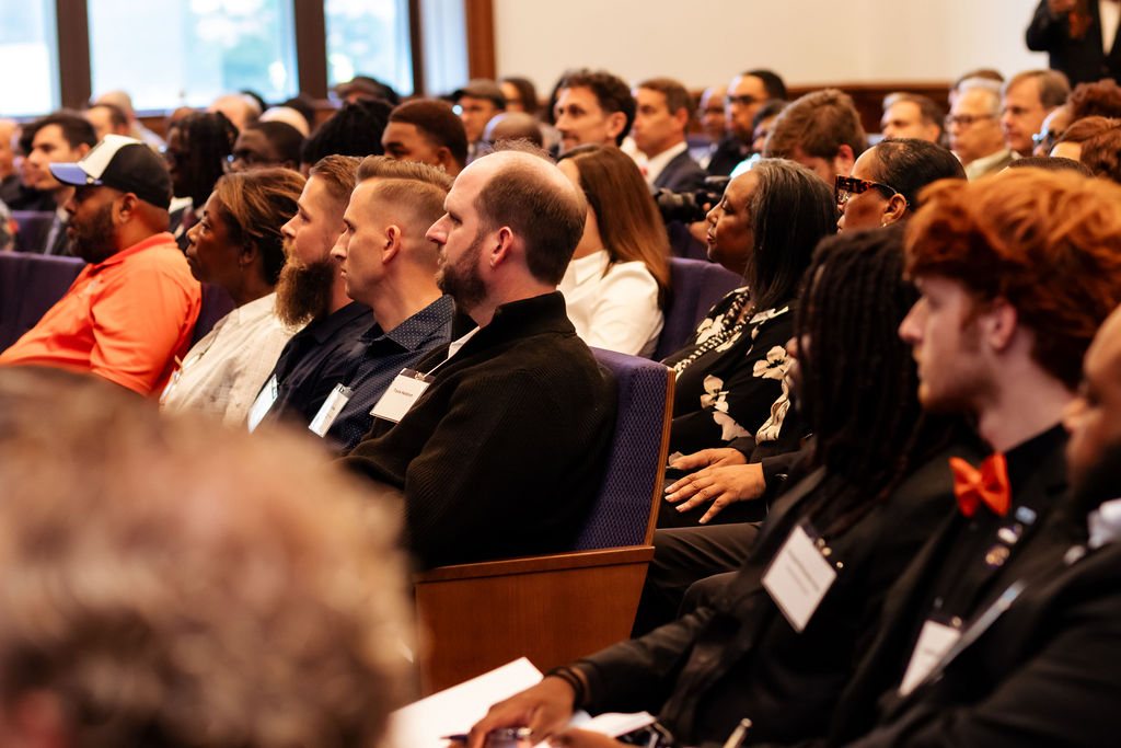 Travis Hellstrom listening among the audience in the chamber
